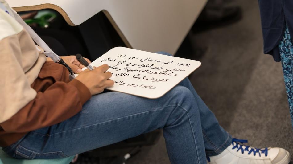Student practises writing arabic script