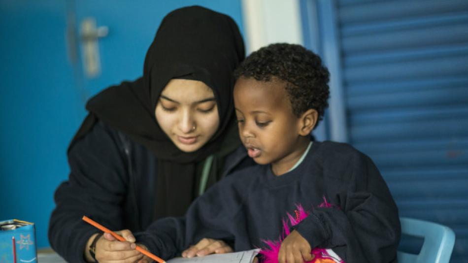 A teacher working with their student