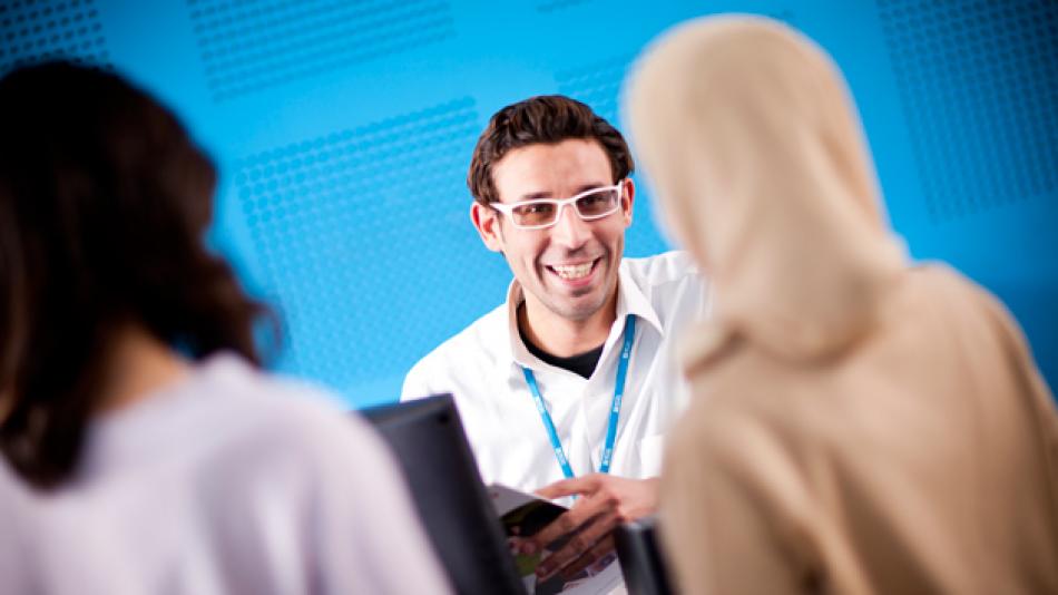 A British Council staff member talking to customers