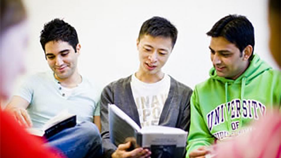 Three young men studying before an exam