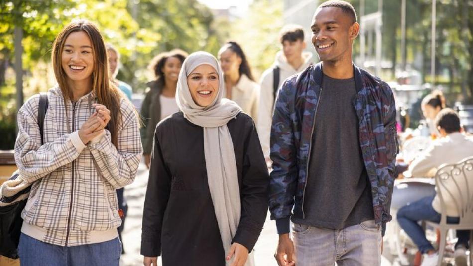 Photo of young people walking through a city