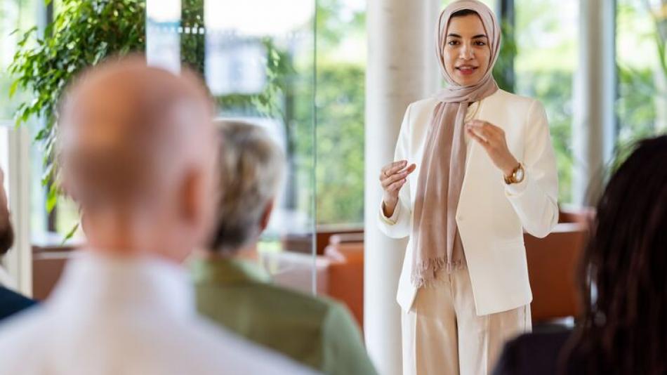 An individual speaking to an audience