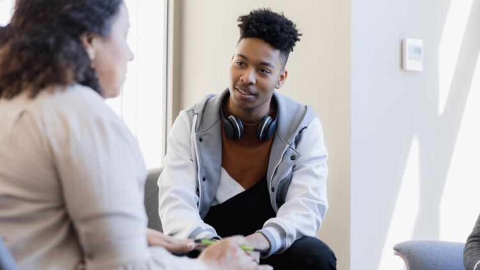 Counsellor talks to young man 