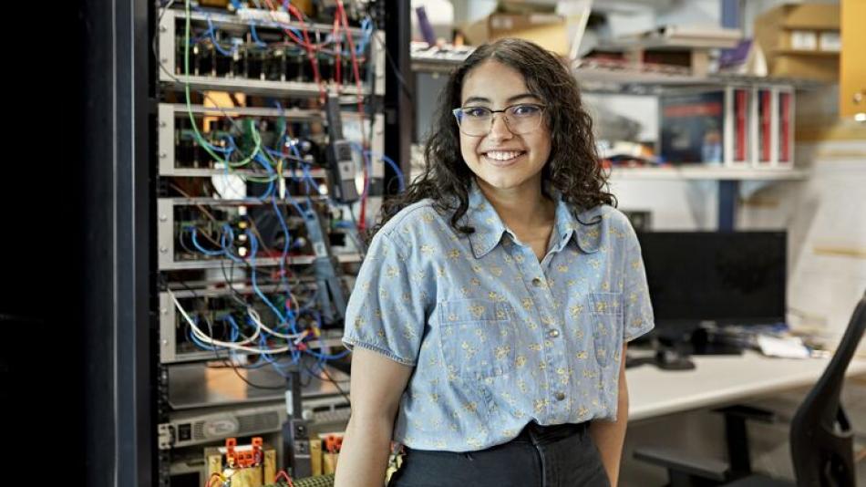 A female engineer stood in front of machinery