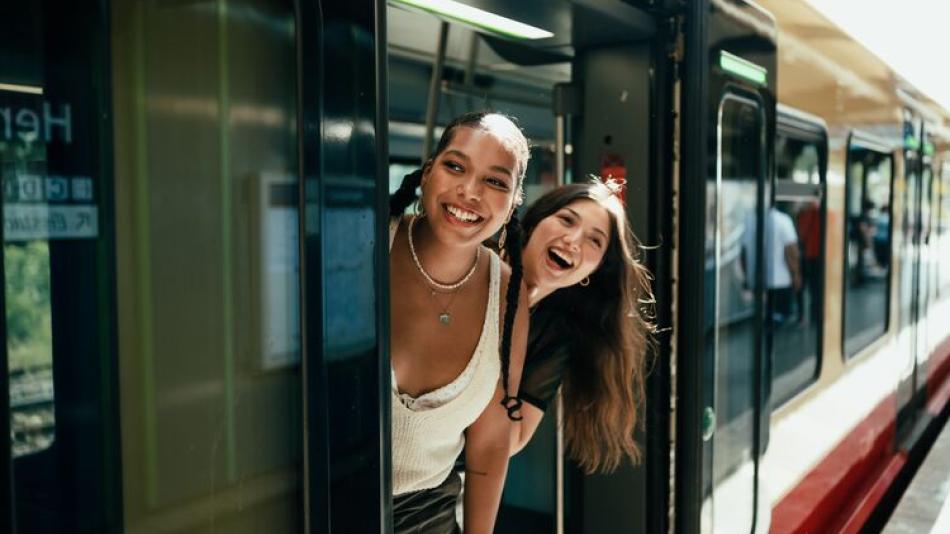 Young women looking out of a train door