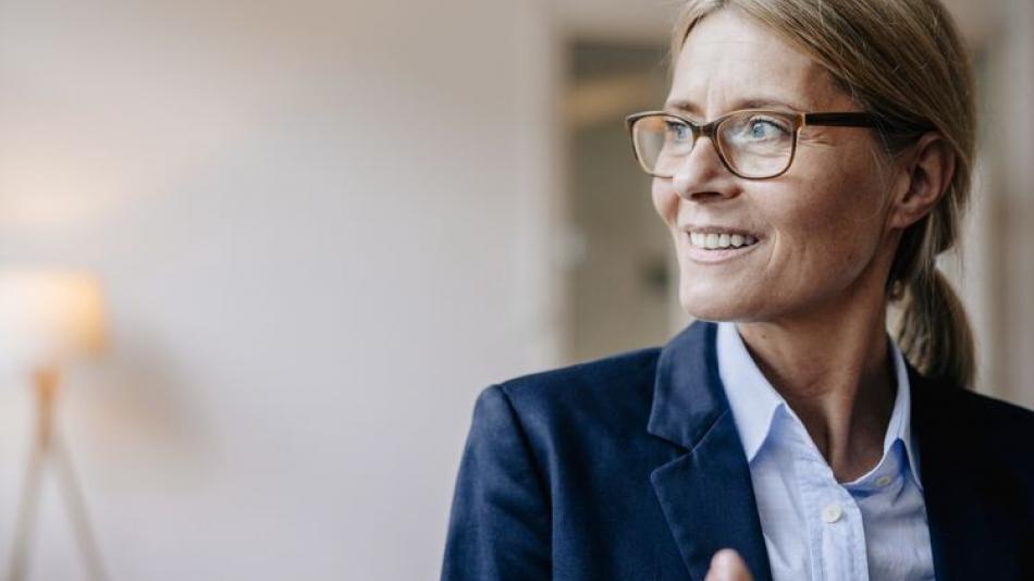 Woman, middle age, glasses, smiling.
