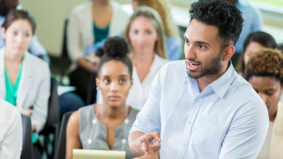 An individual speaking to an audience