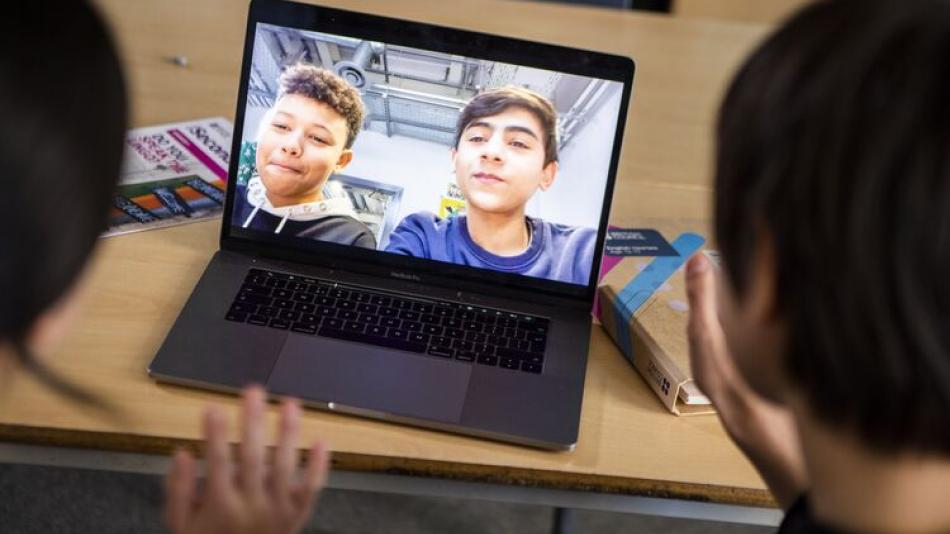 Two pupils in an online call with overseas pupils